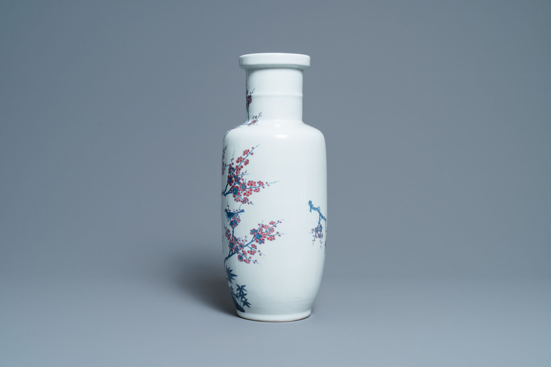 A Chinese blue, white and copper-red rouleau vase with birds among blossoming branches, 20th C. - Image 2 of 6