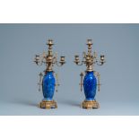 A pair of Chinese blue-ground vases with bronze candelabra mounts, Kangxi and 19th C.