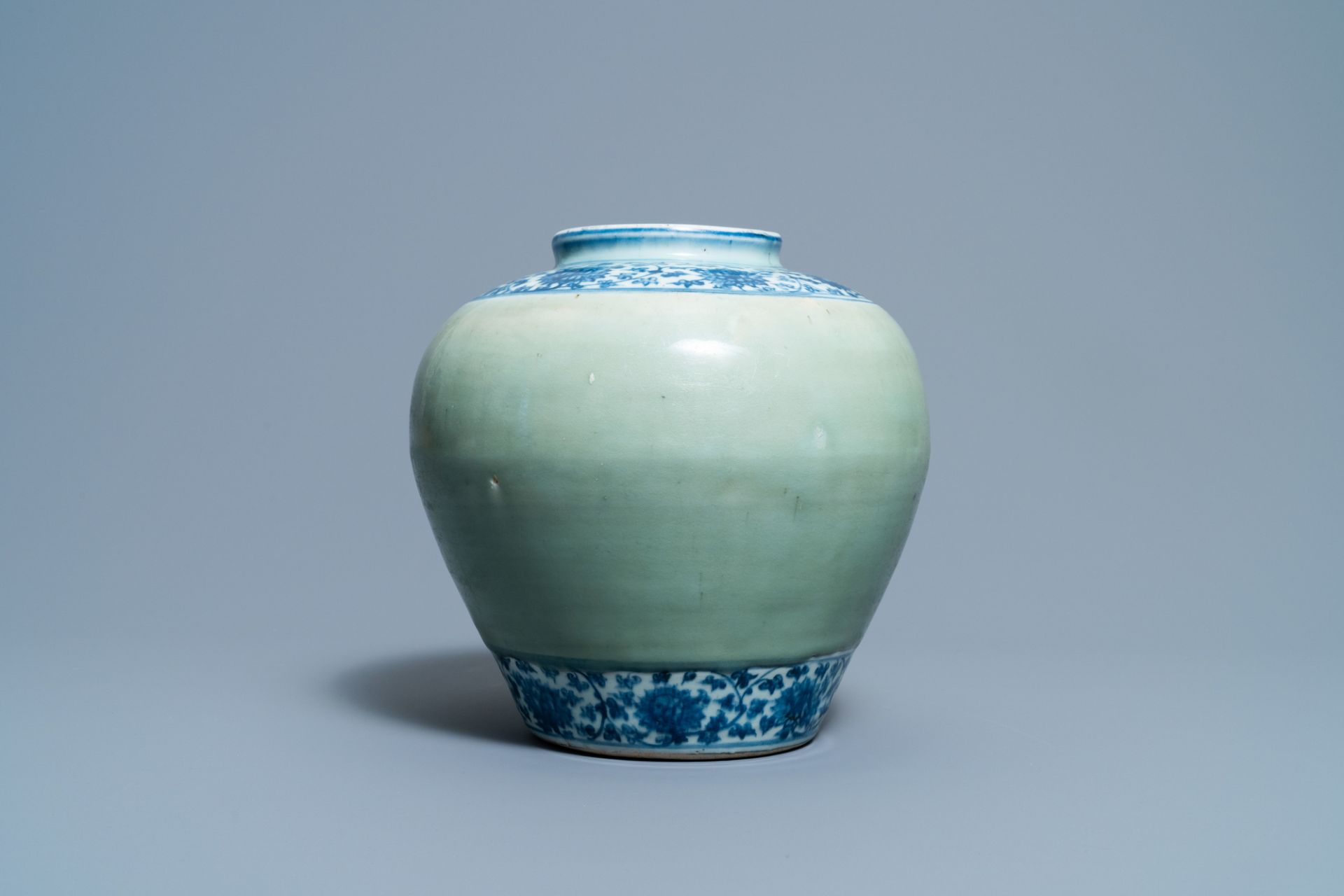 A Chinese celadon-ground and blue and white 'lotus scroll' jar, Ming - Image 5 of 7