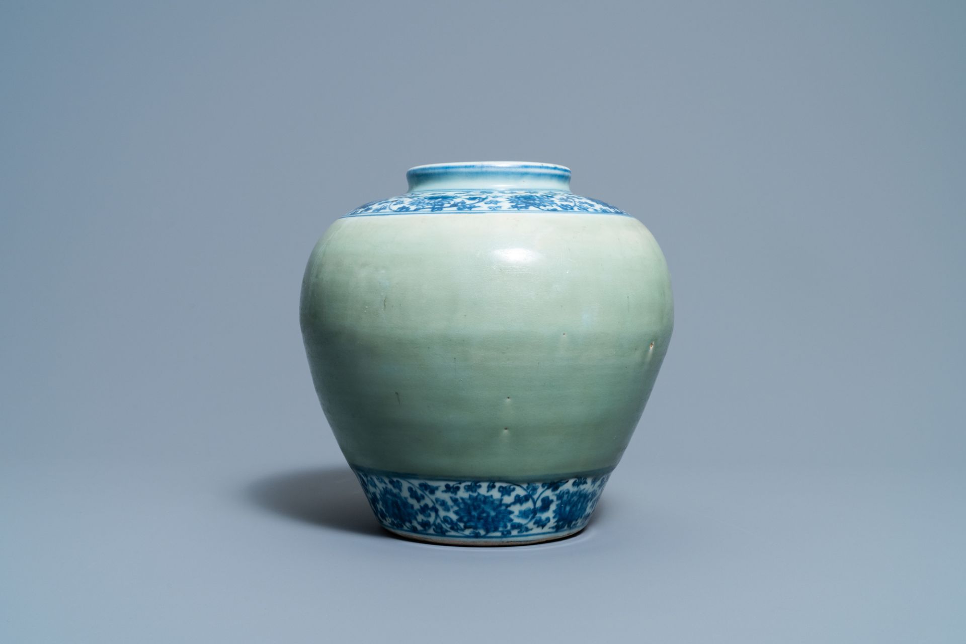 A Chinese celadon-ground and blue and white 'lotus scroll' jar, Ming - Image 4 of 7