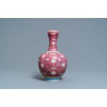 A Chinese famille rose ruby-ground bottle vase, Qianlong mark, 19/20th C.