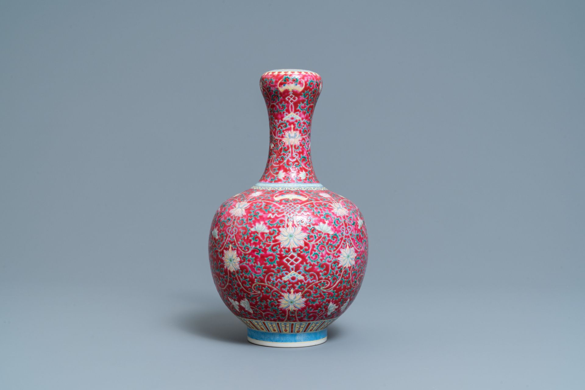 A Chinese famille rose ruby-ground bottle vase, Qianlong mark, 19/20th C.