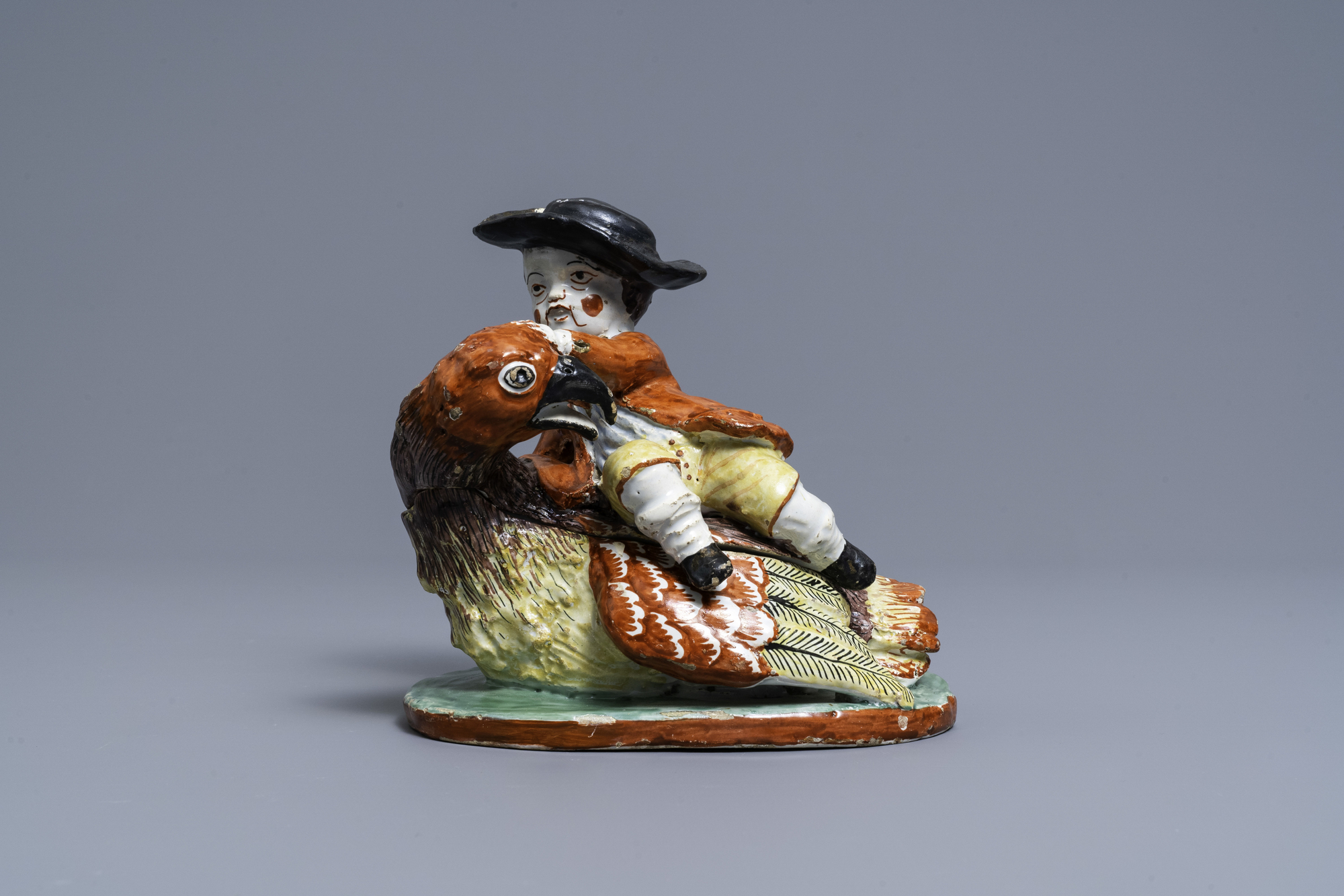 A polychrome Dutch Delft box and cover in the shape of a boy on a bird, 18th C. - Image 2 of 7