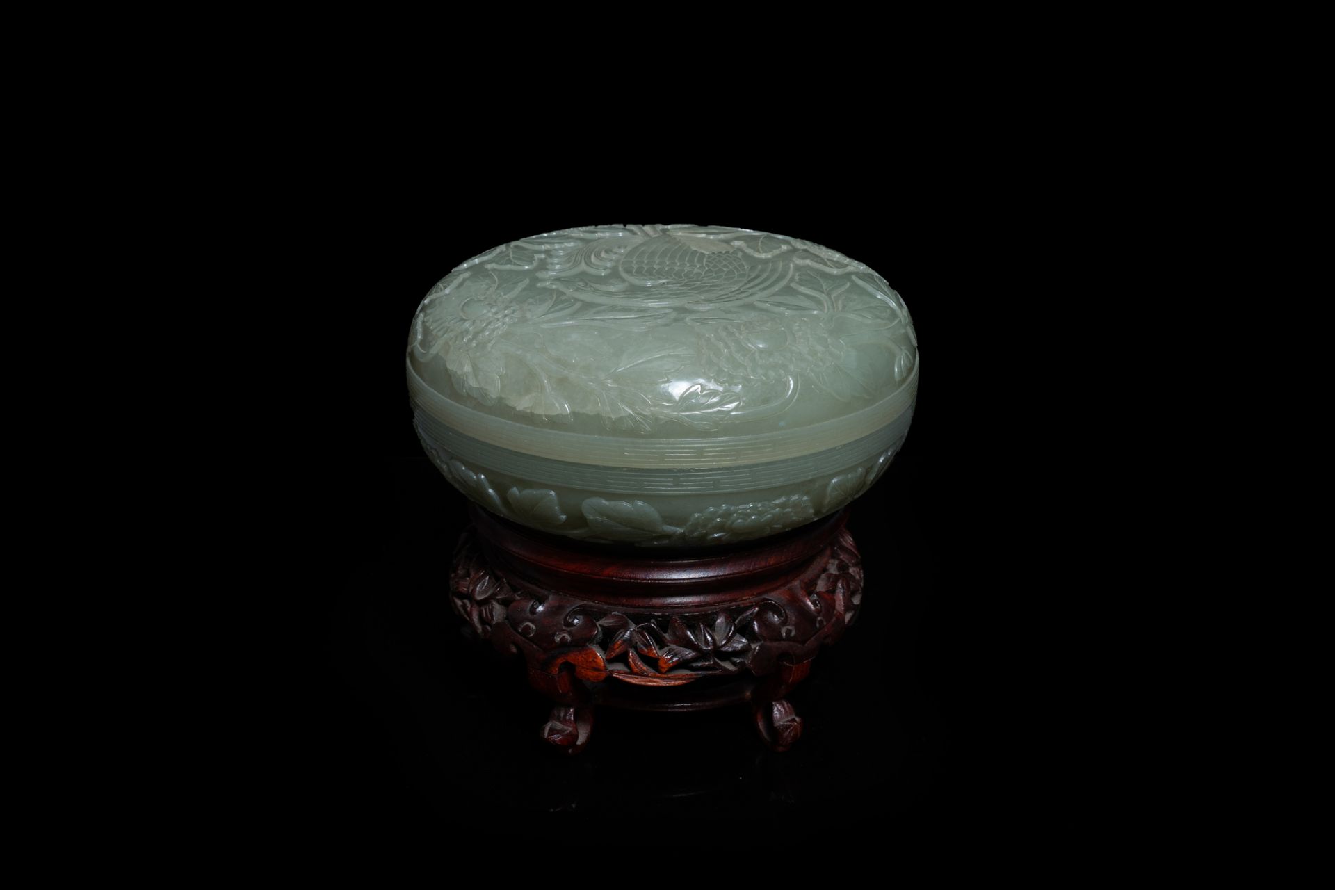 A Chinese pale celadon jade 'phoenix and peony' circular box and cover, 19th C.