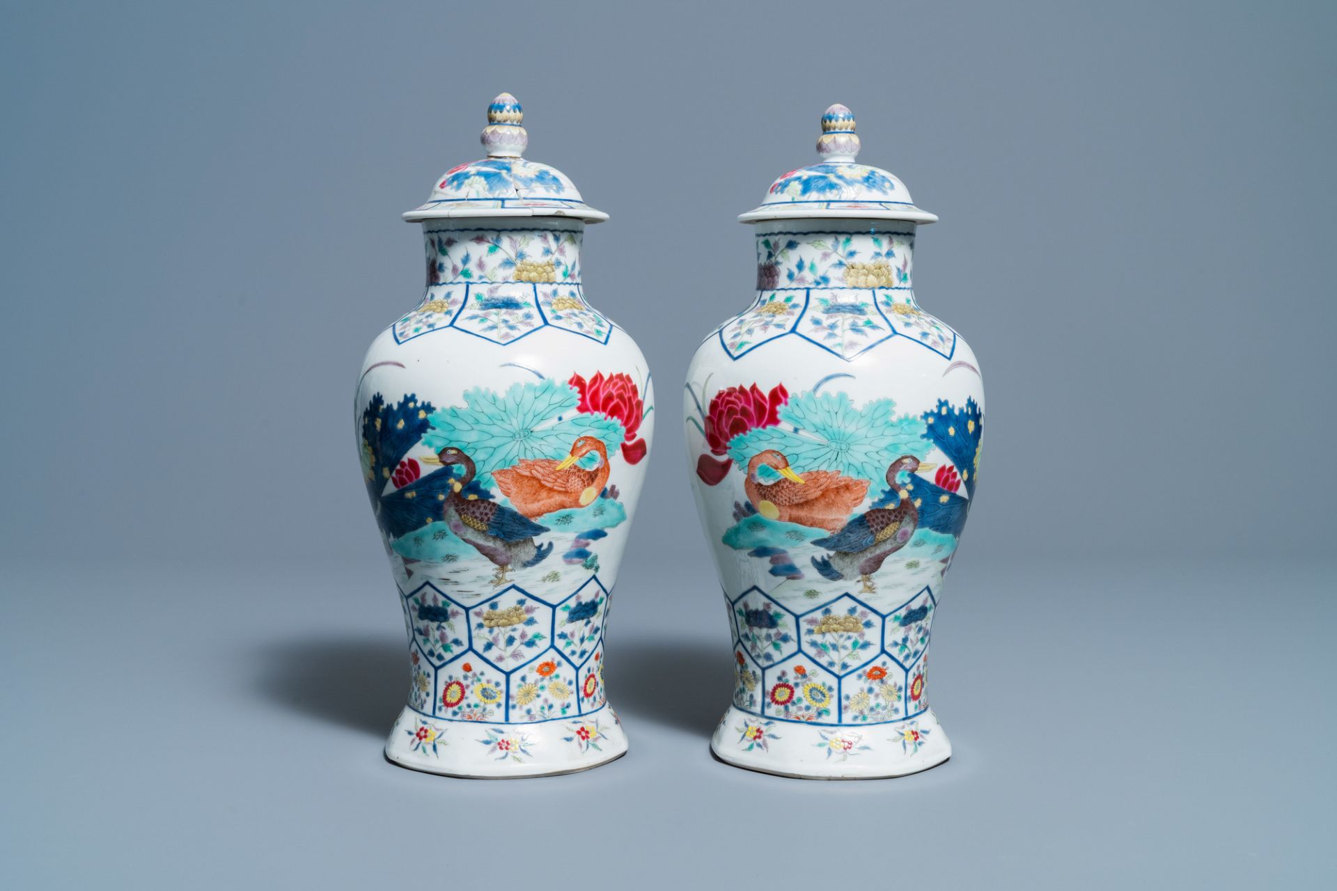 A pair of Chinese famille rose 'mandarin ducks' vases and covers, Kangxi mark, Republic