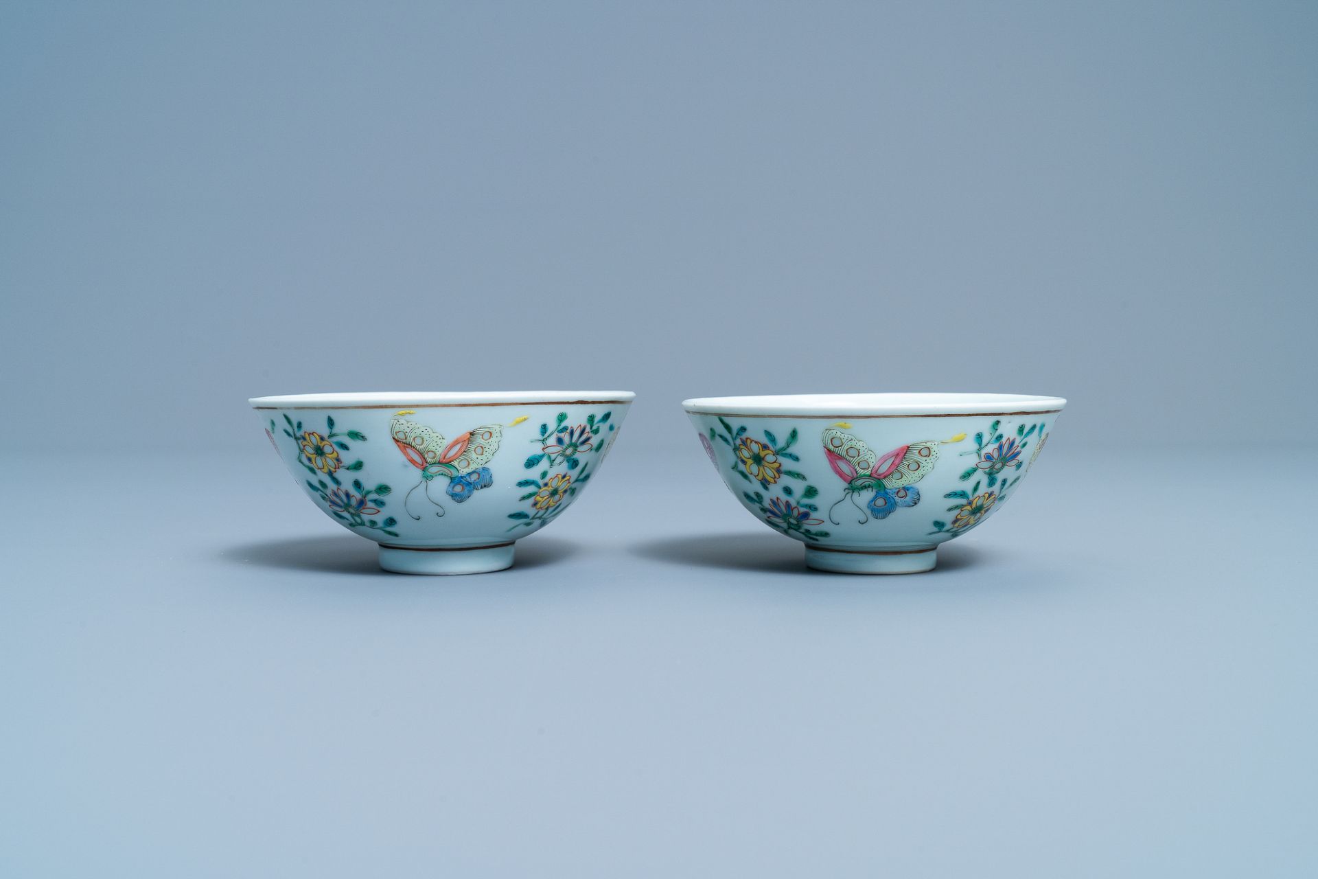 A pair of Chinese famille rose rice grain pattern 'butterfly' bowls, Qianlong mark, 19th C. - Image 2 of 10