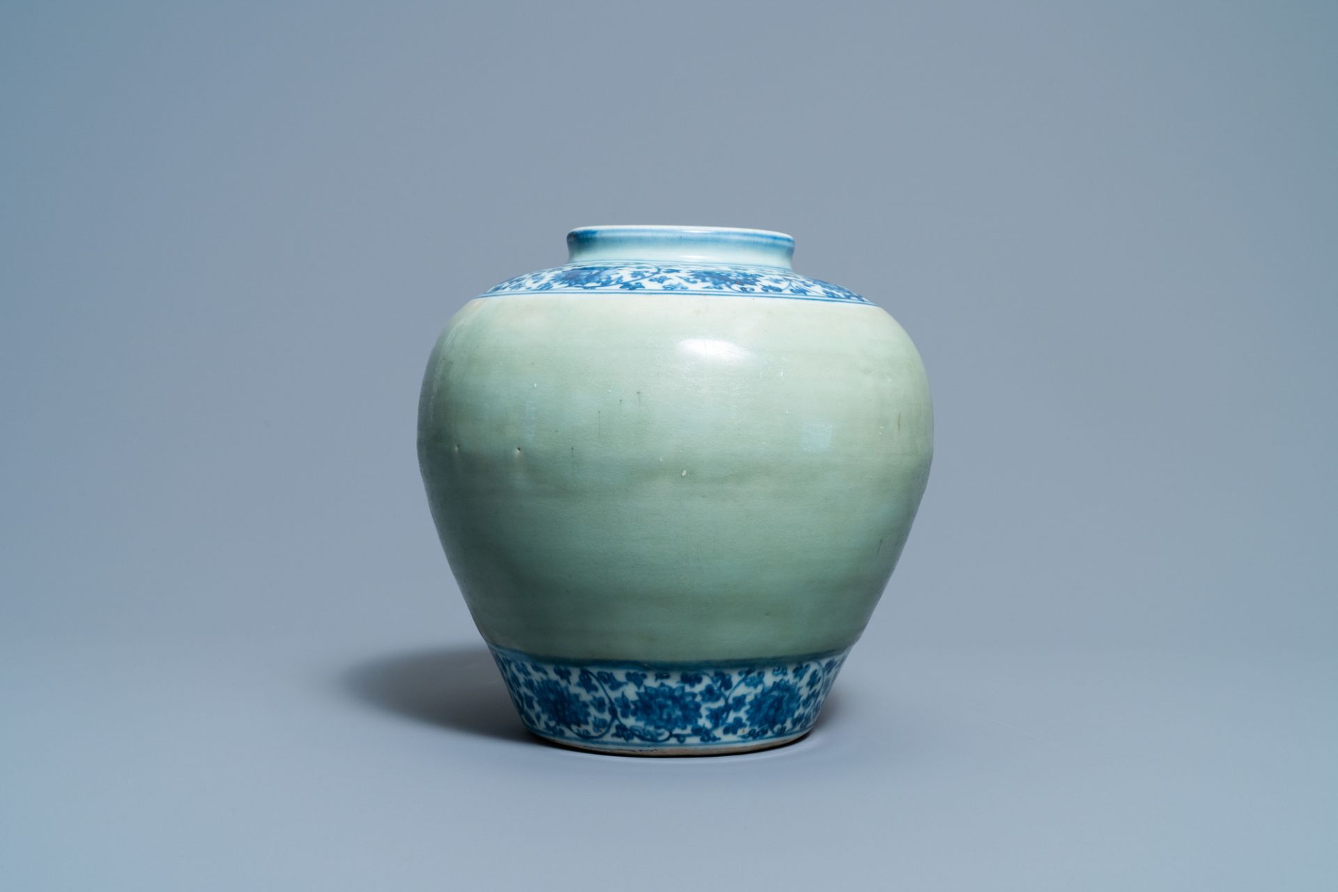 A Chinese celadon-ground and blue and white 'lotus scroll' jar, Ming - Image 3 of 7