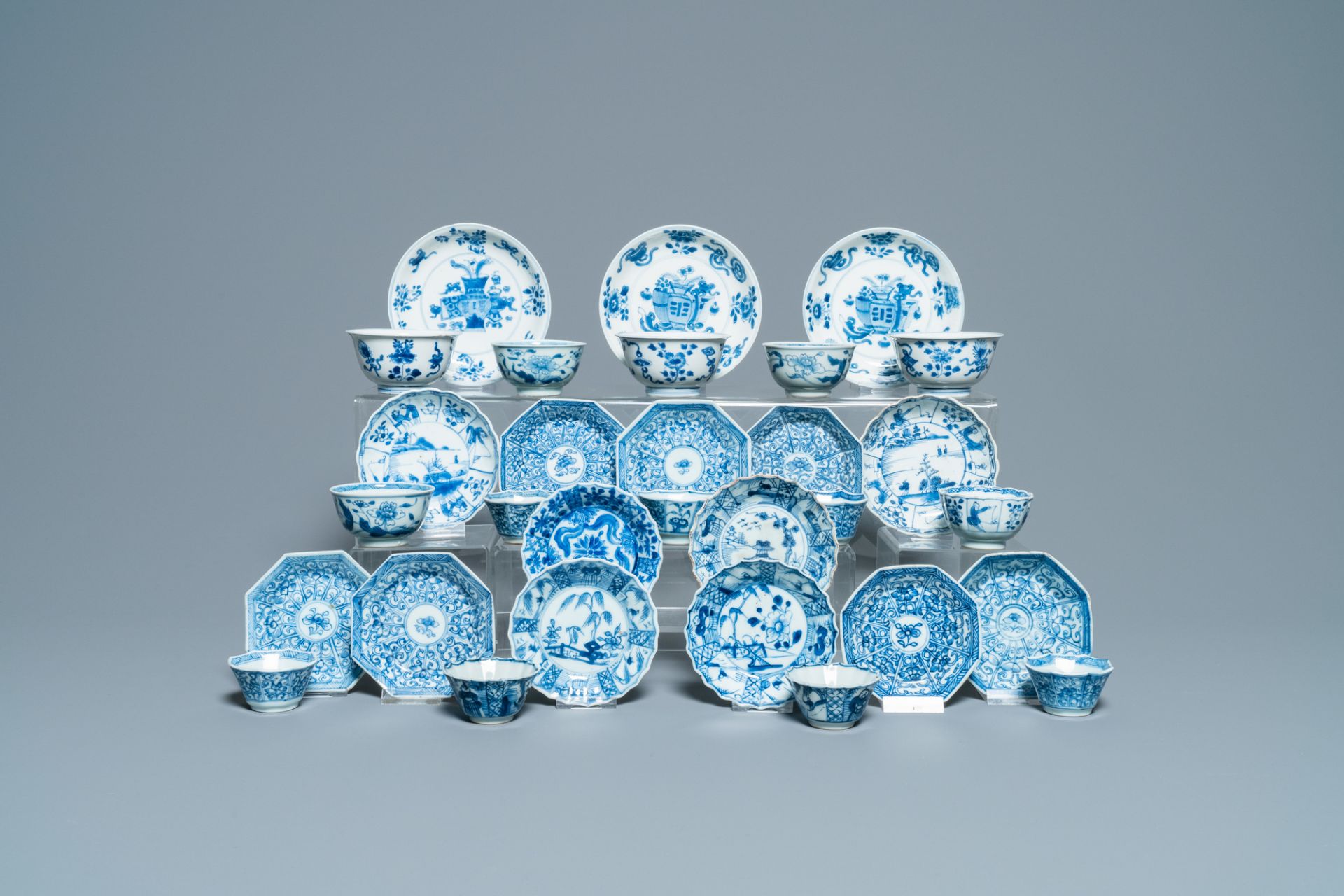 Sixteen Chinese blue and white saucers and fourteen cups, Kangxi