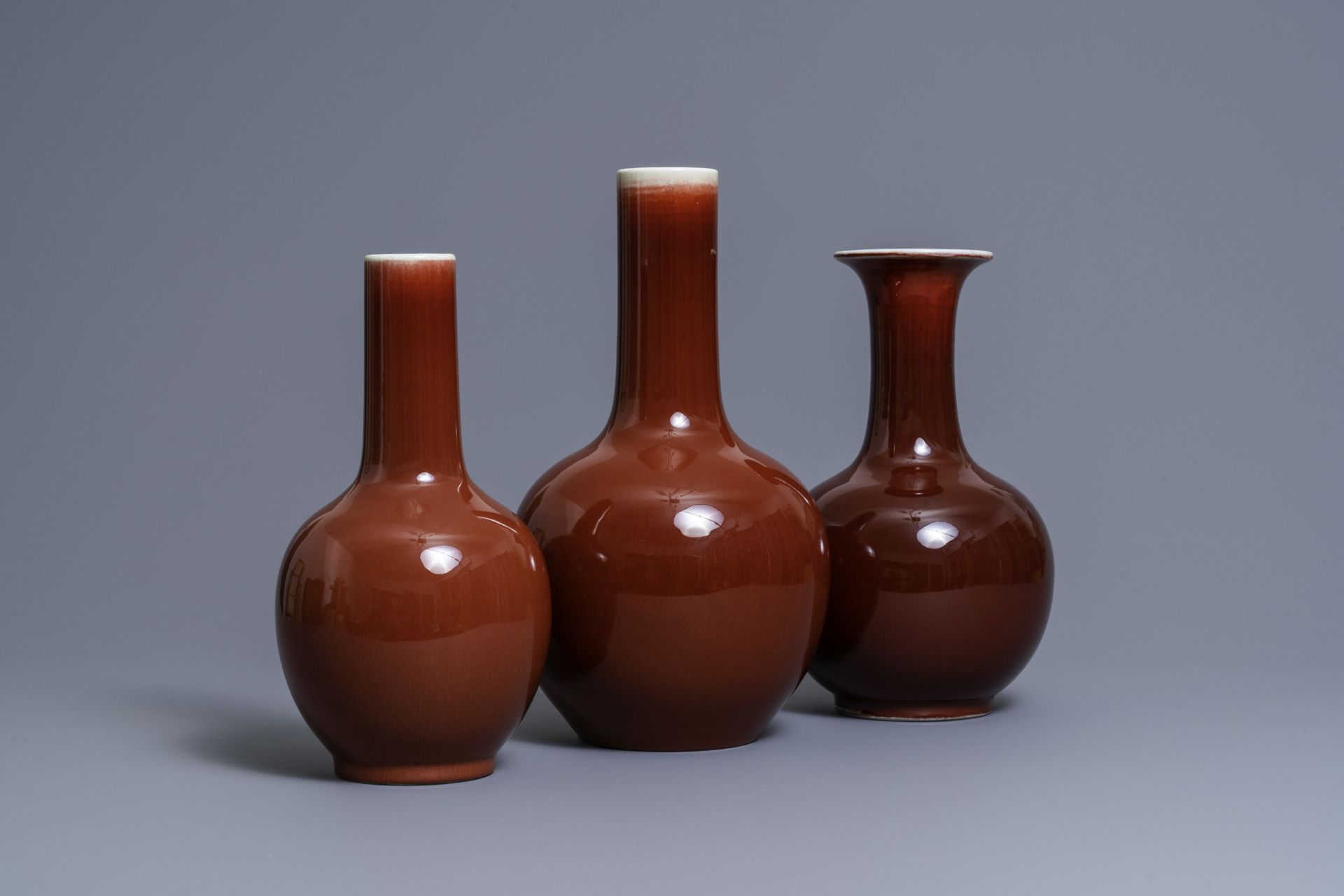 Three Chinese monochrome sang de boeuf-glazed bottle vases, 19/20th C.