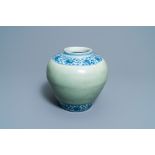 A Chinese celadon-ground and blue and white 'lotus scroll' jar, Ming