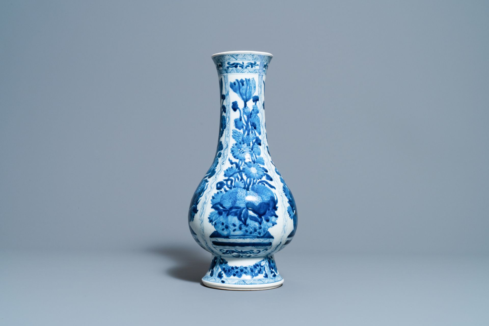 A Chinese blue and white bottle vase with flower arrangements, Kangxi - Image 4 of 6