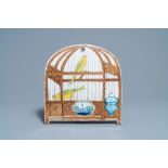 A rare polychrome Dutch Delft trompe l'oeil plaque with two canaries in a birdcage, 18th C.