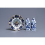 A pair of Dutch Delft blue and white vases and a 'peacock's tail' plate, 18th C.