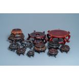 Twelve large round Chinese carved wooden stands, 19/20th C.