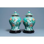 A pair of Chinese turquoise-ground famille verte vases and covers, 19th C.
