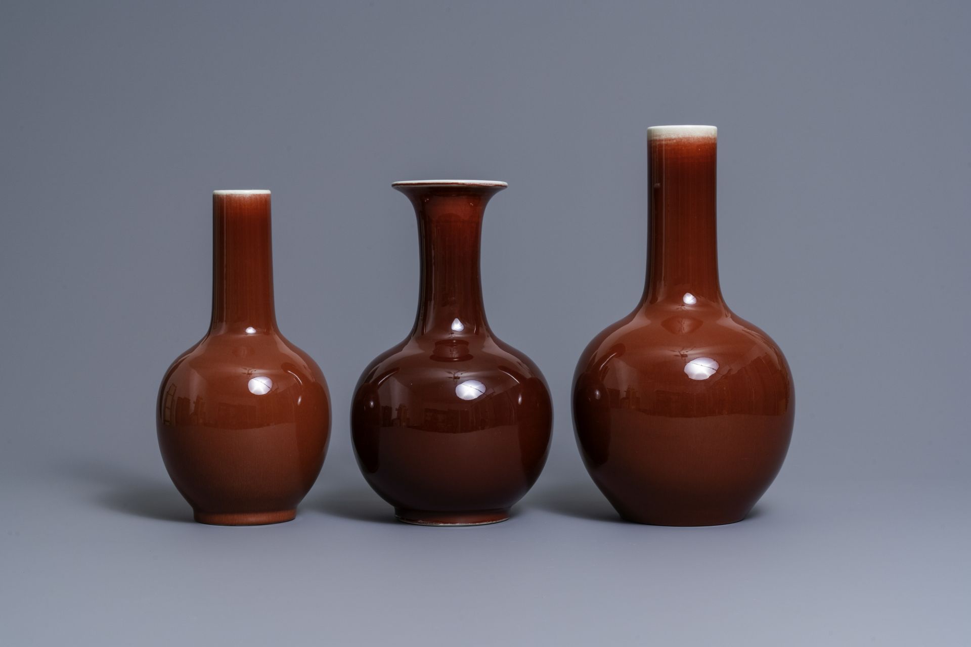 Three Chinese monochrome sang de boeuf-glazed bottle vases, 19/20th C. - Image 2 of 7