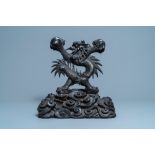 A large Chinese carved wooden 'dragon' stand for a dish or a mirror, 19th C.