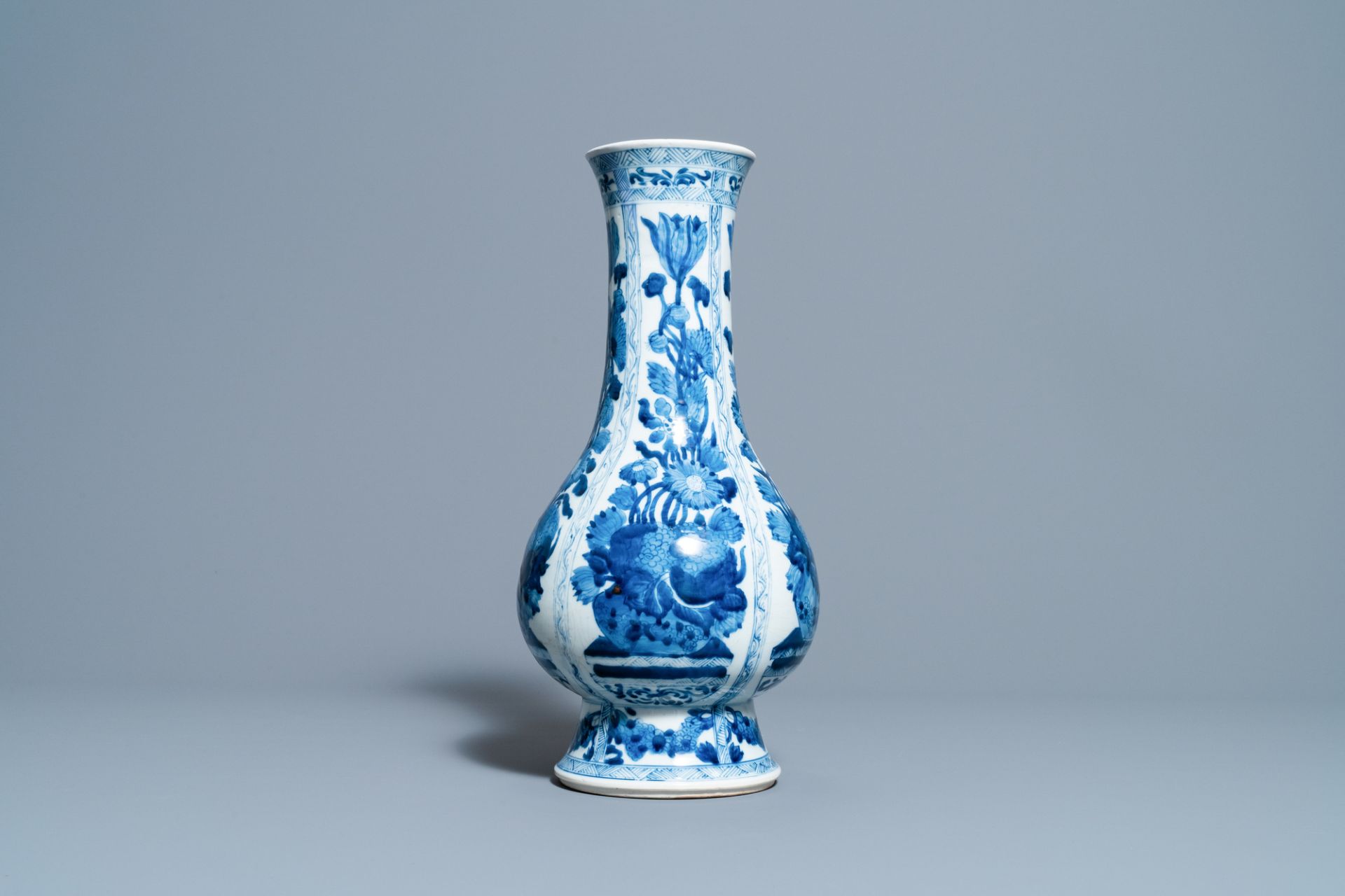 A Chinese blue and white bottle vase with flower arrangements, Kangxi - Image 3 of 6