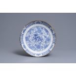 A ribbed Dutch Delft blue and white chinoiserie 'dragon' dish, 18th C.