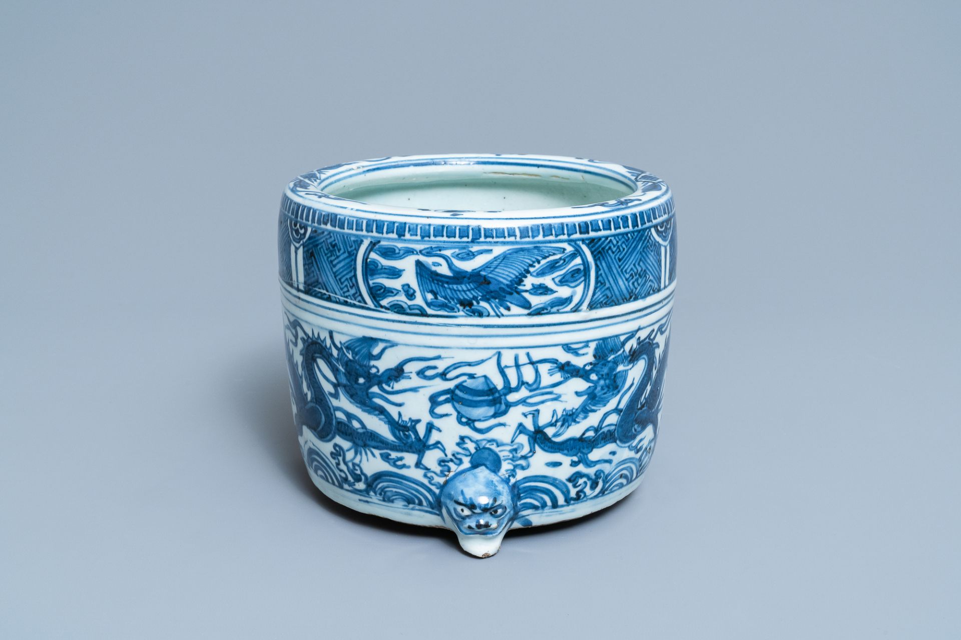 A Chinese blue and white 'dragon' tripod censer, Ming