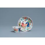 A Chinese famille rose 'tea scene' cup and saucer, Yongzheng/Qianlong