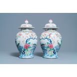 A pair of Chinese famille rose 'pheasants' vases and covers, 19th C.