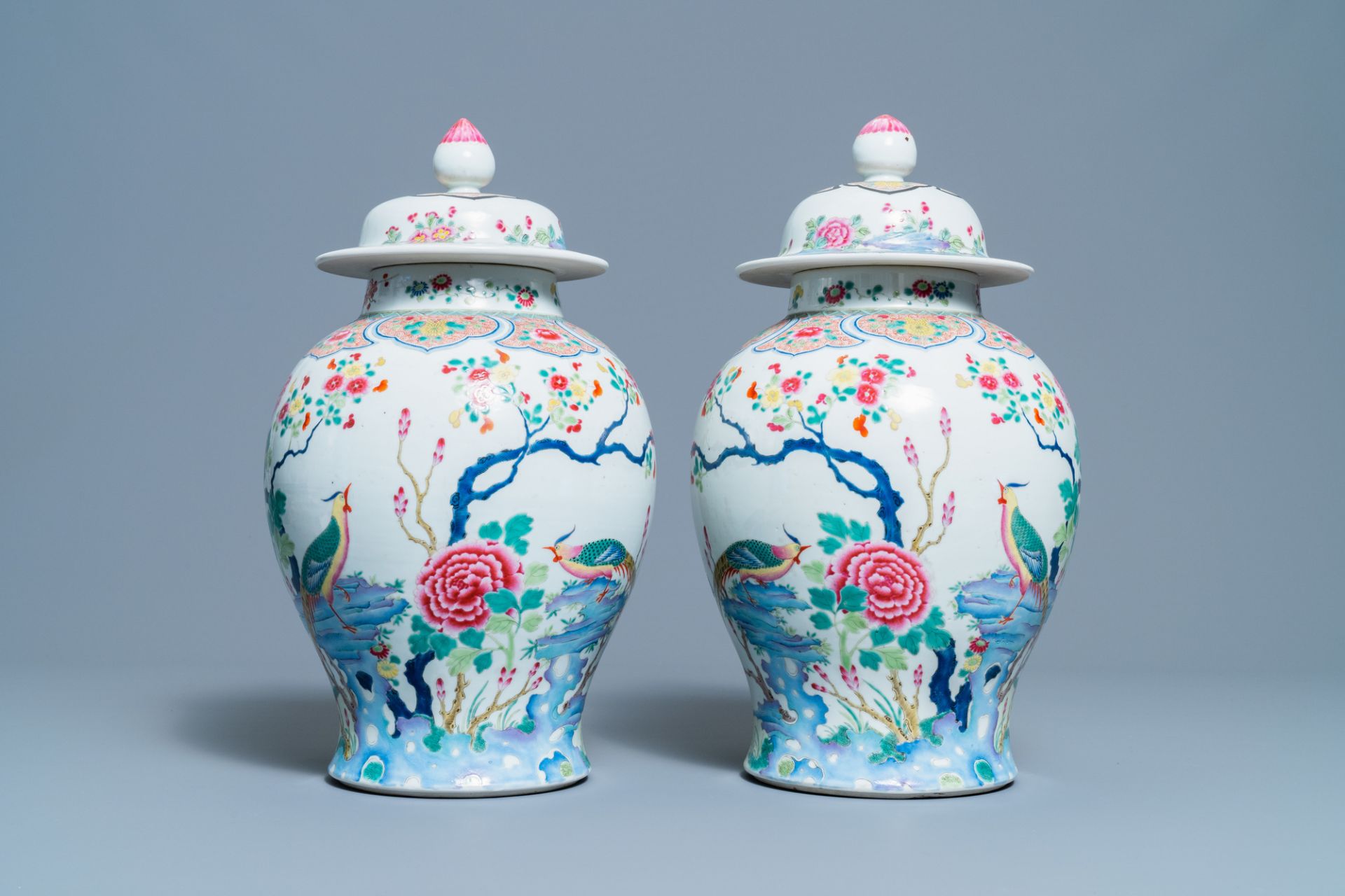 A pair of Chinese famille rose 'pheasants' vases and covers, 19th C.