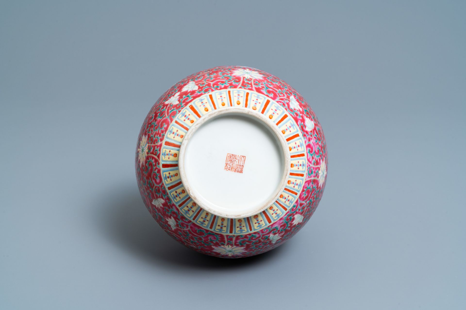 A Chinese famille rose ruby-ground bottle vase, Qianlong mark, 19/20th C. - Image 6 of 6