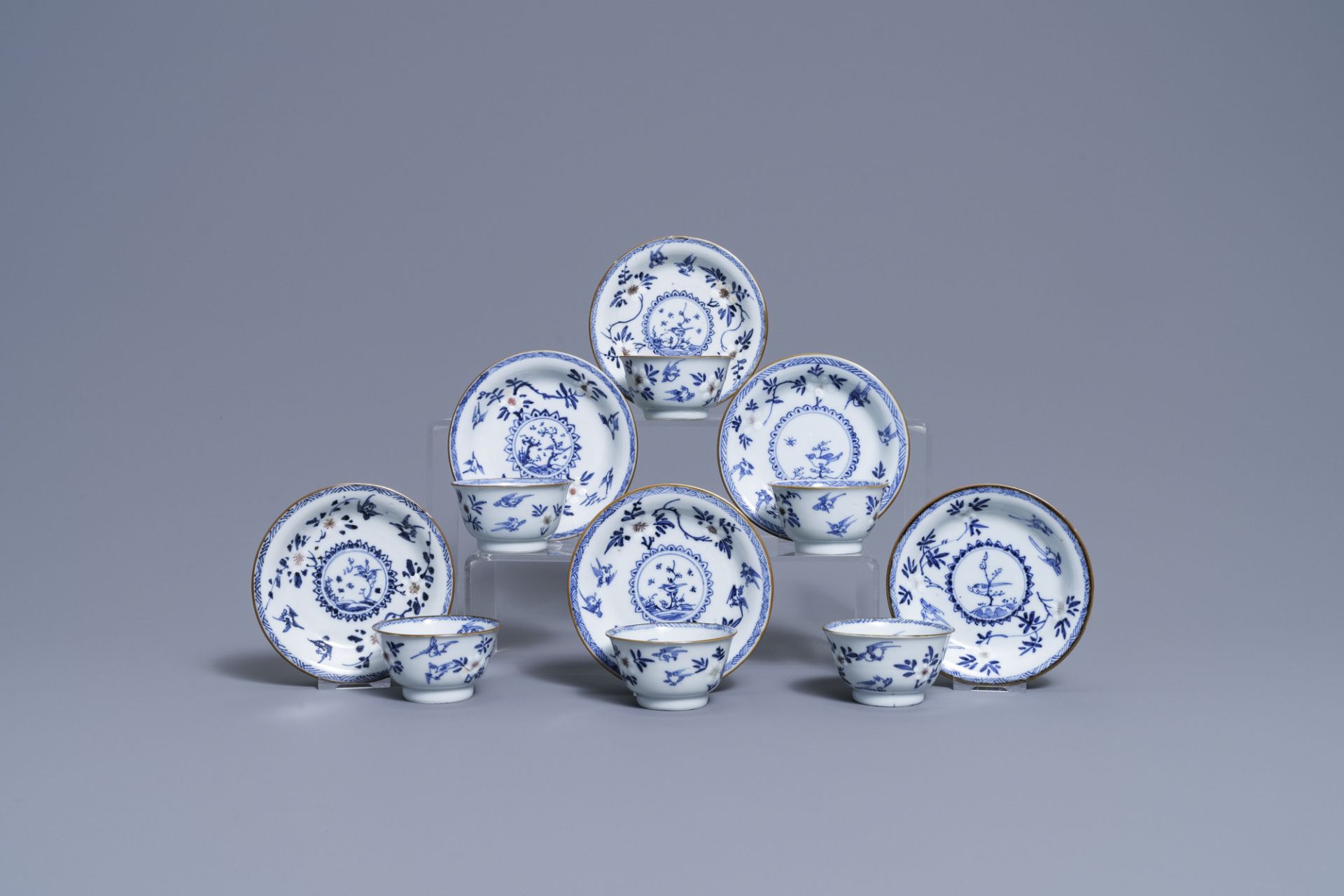 Six Chinese blue, white and copper-red cups and saucers, Kangxi