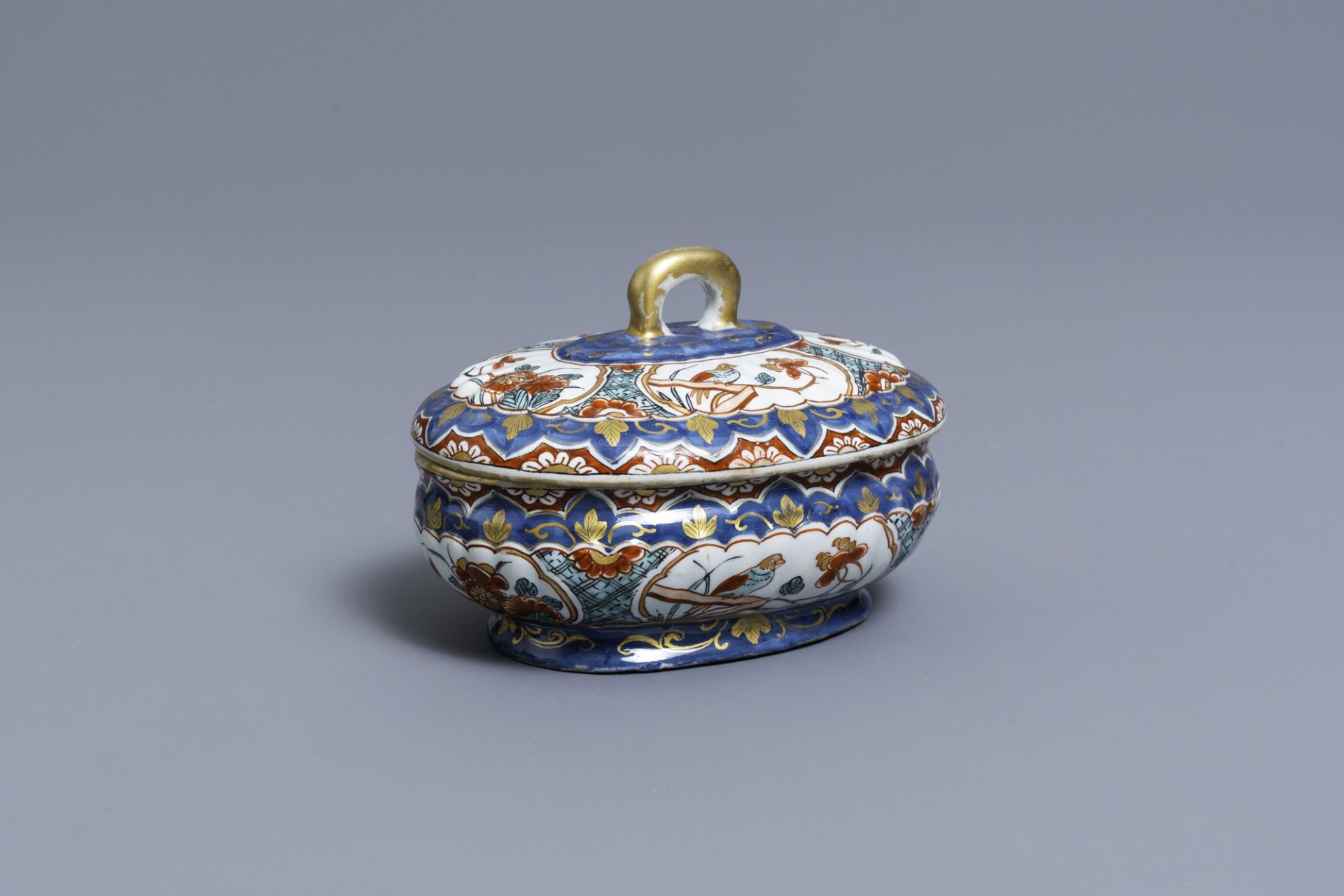 A polychrome and gilded Dutch Delft spice box and cover, early 18th C.