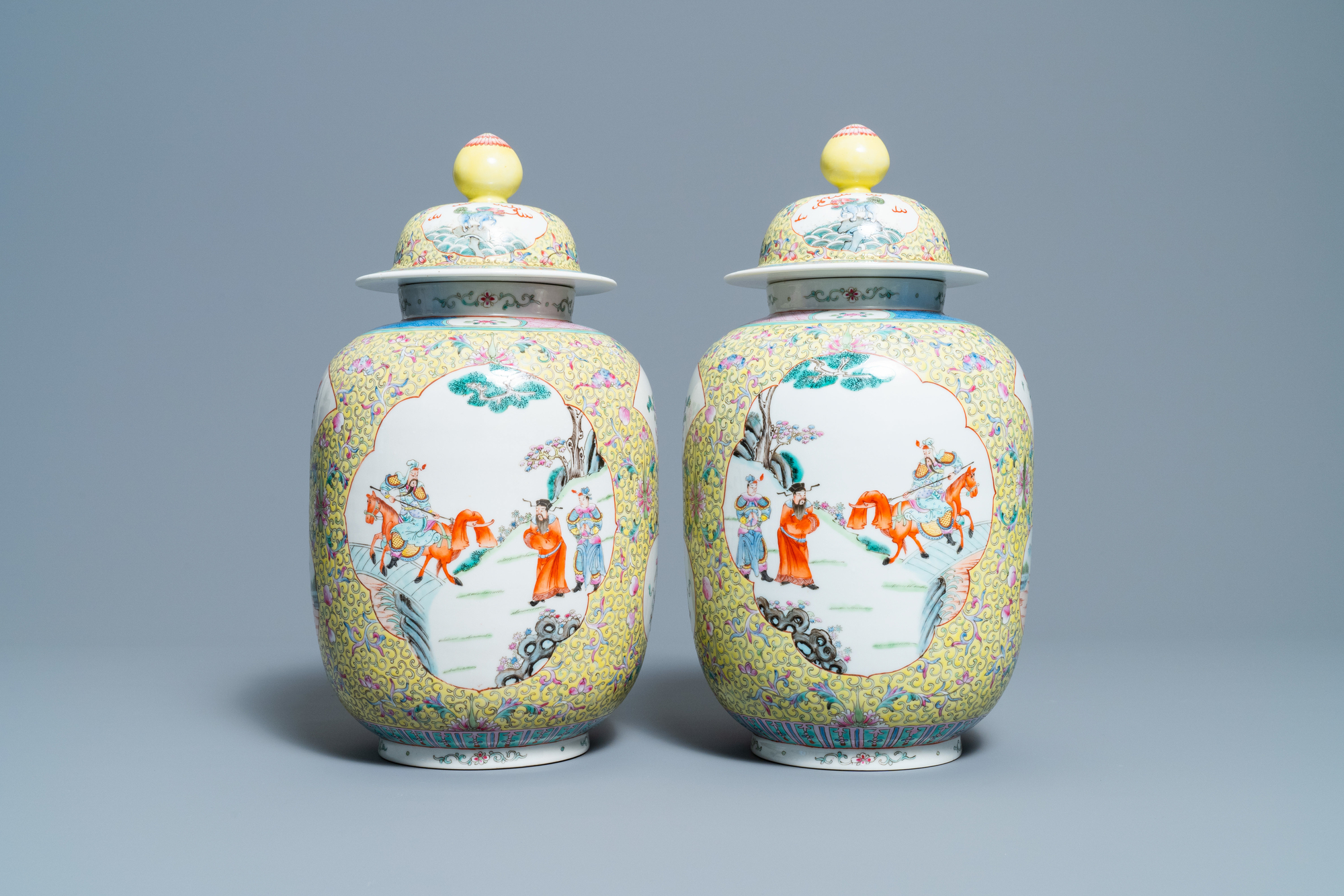 A pair of Chinese famille rose yellow-ground vases and covers, Guangxu mark, Republic