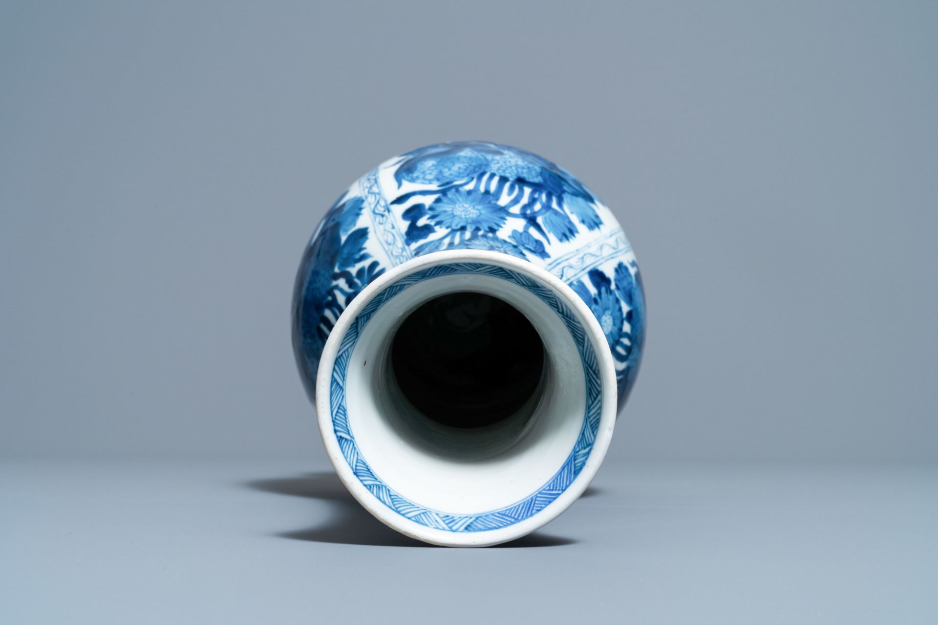 A Chinese blue and white bottle vase with flower arrangements, Kangxi - Image 5 of 6