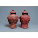 A pair of Chinese red cinnabar lacquer vases and covers, Zhengde mark, Qing