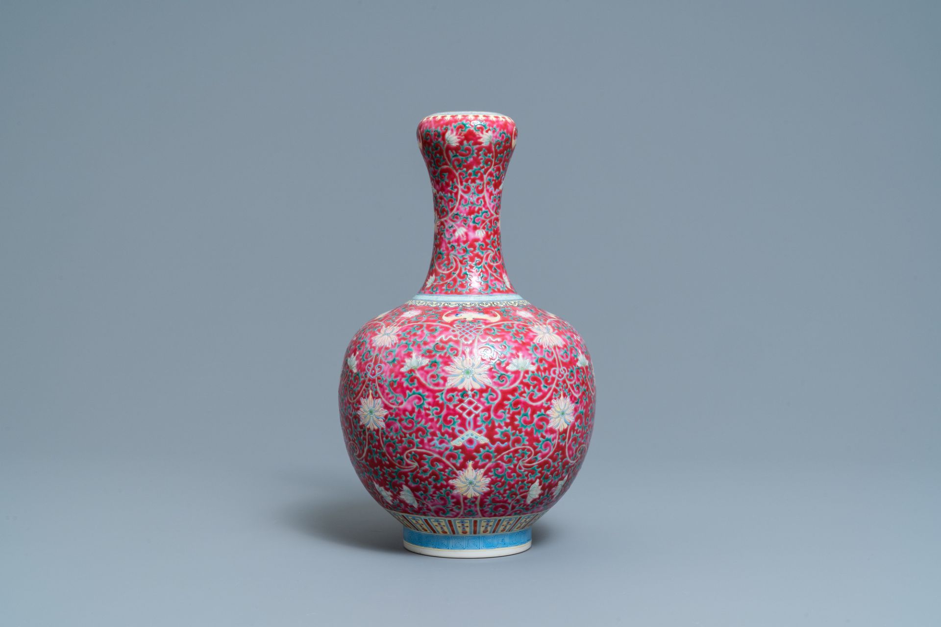 A Chinese famille rose ruby-ground bottle vase, Qianlong mark, 19/20th C. - Image 4 of 6