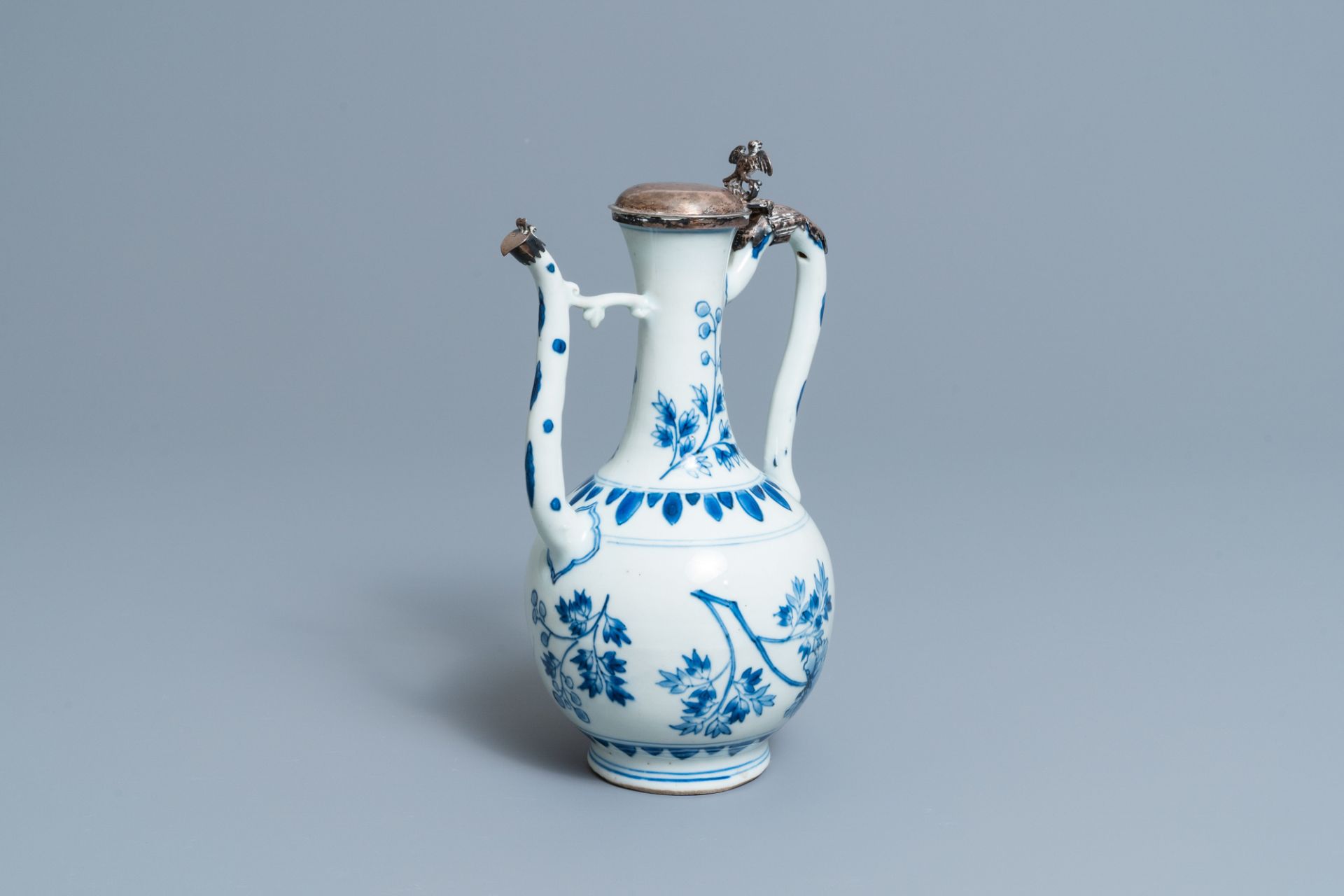 A Chinese blue and white silver-mounted ewer and cover, Transitional period