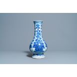 A Chinese blue and white bottle vase with flower arrangements, Kangxi