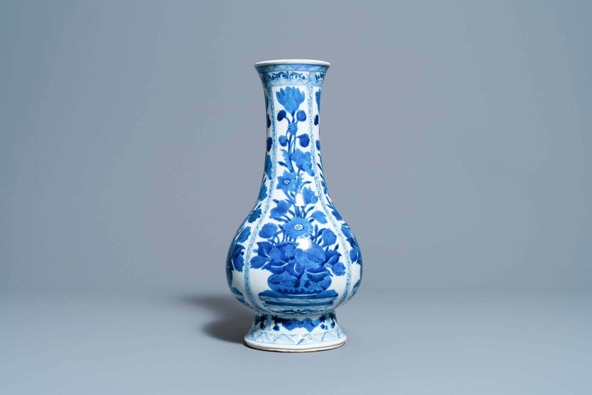 A Chinese blue and white bottle vase with flower arrangements, Kangxi