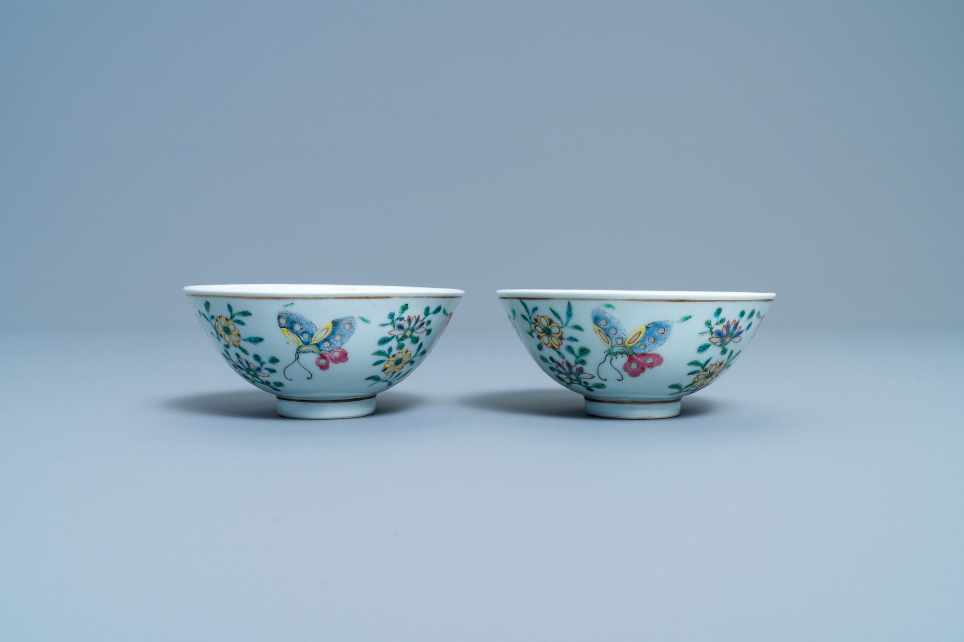 A pair of Chinese famille rose rice grain pattern 'butterfly' bowls, Qianlong mark, 19th C. - Image 4 of 10