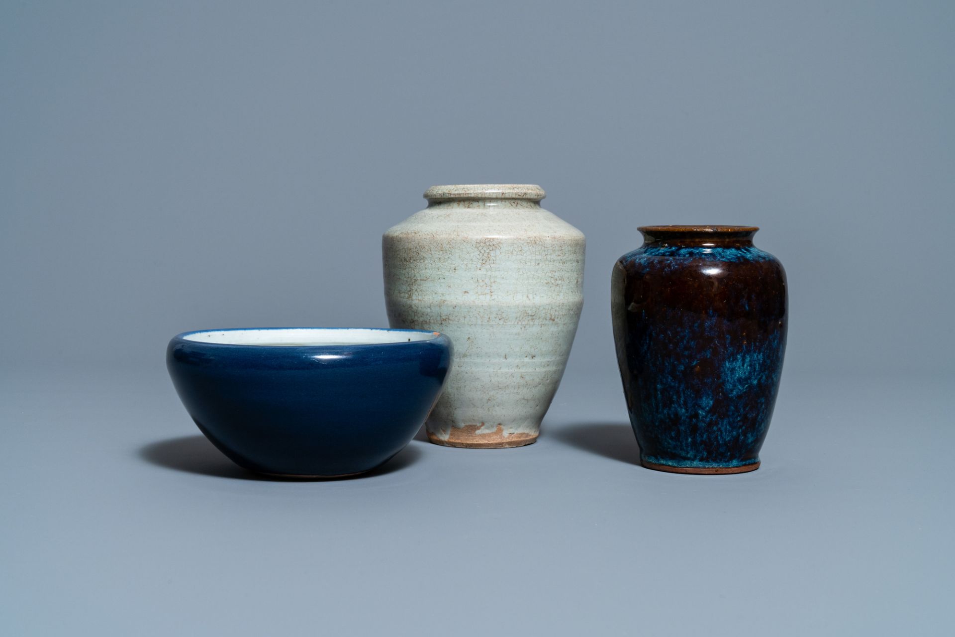 A Chinese flambe-glazed vase, a cream-glazed vase and a blue-glazed censer, Qing