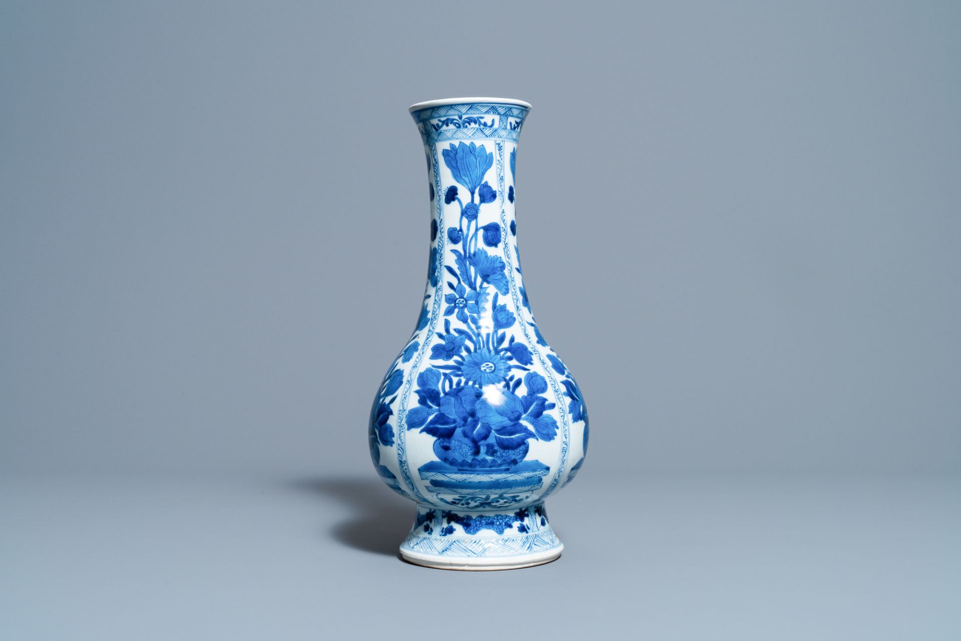 A Chinese blue and white bottle vase with flower arrangements, Kangxi - Image 4 of 6