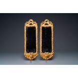 A pair of gilded wooden mirrors with candle holders, France or Italy, 17/18th C.