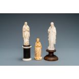 Two figures of Madonna and one of Christ in ivory and bone, 19th C.