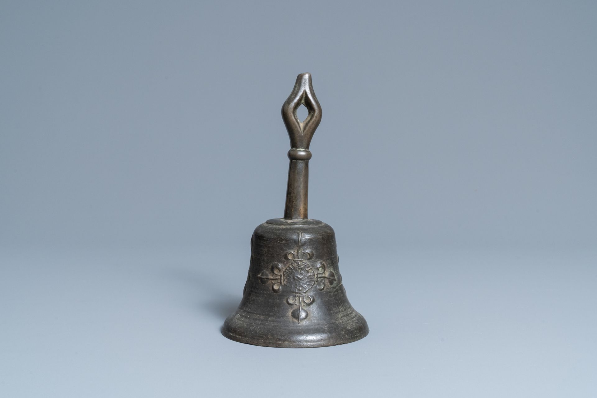 A bronze bell with applied fleur-de-lis and an IHS medallion, France, 16th C.