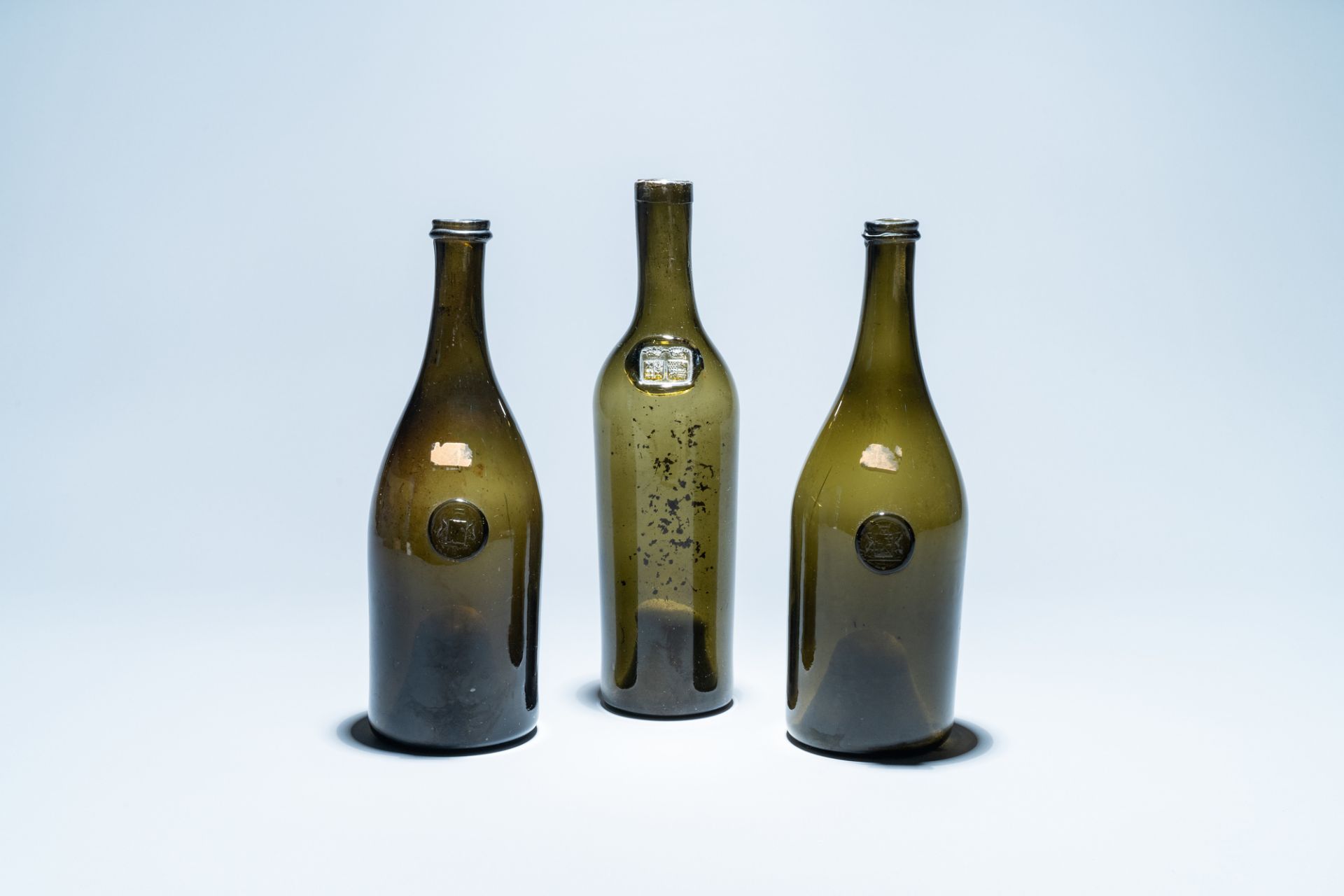 Three green glass wine bottles with crowned seals, 18/19th C.