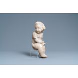 An alabaster figure of a putto with a bird on the knee, 17th C.