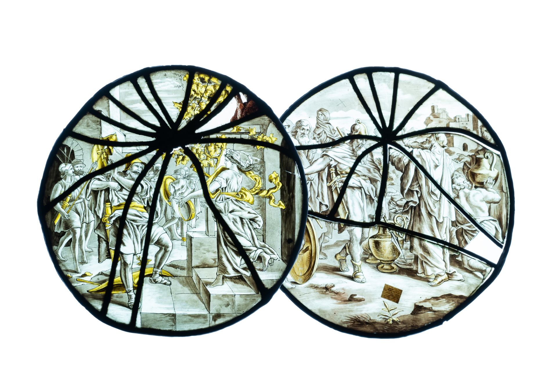 A pair of grisaille and silver yellow painted glass roundels with biblical scenes, France, 17th C.