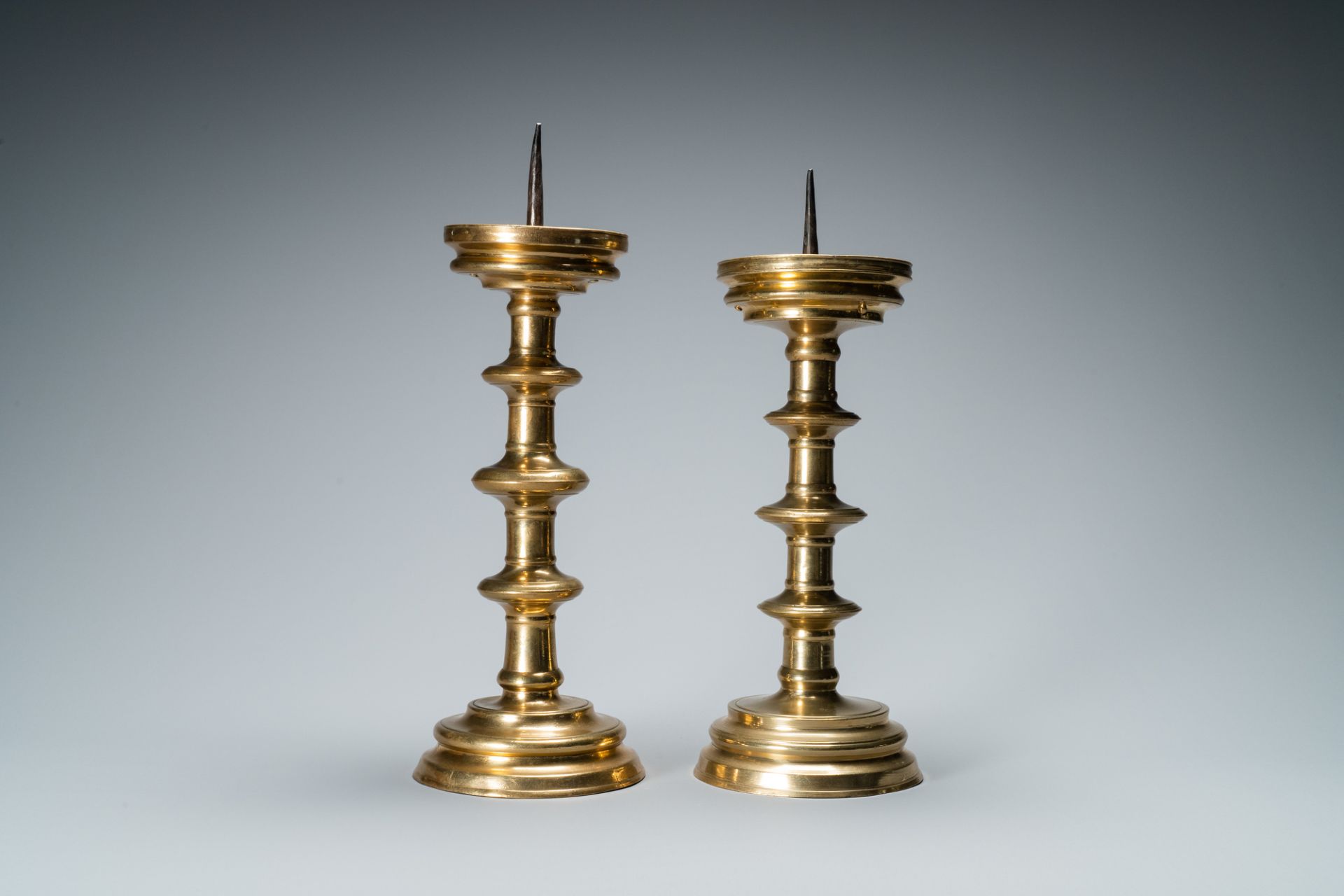 A composite pair of brass alloy candlesticks, Germany, 16th C. - Image 2 of 7