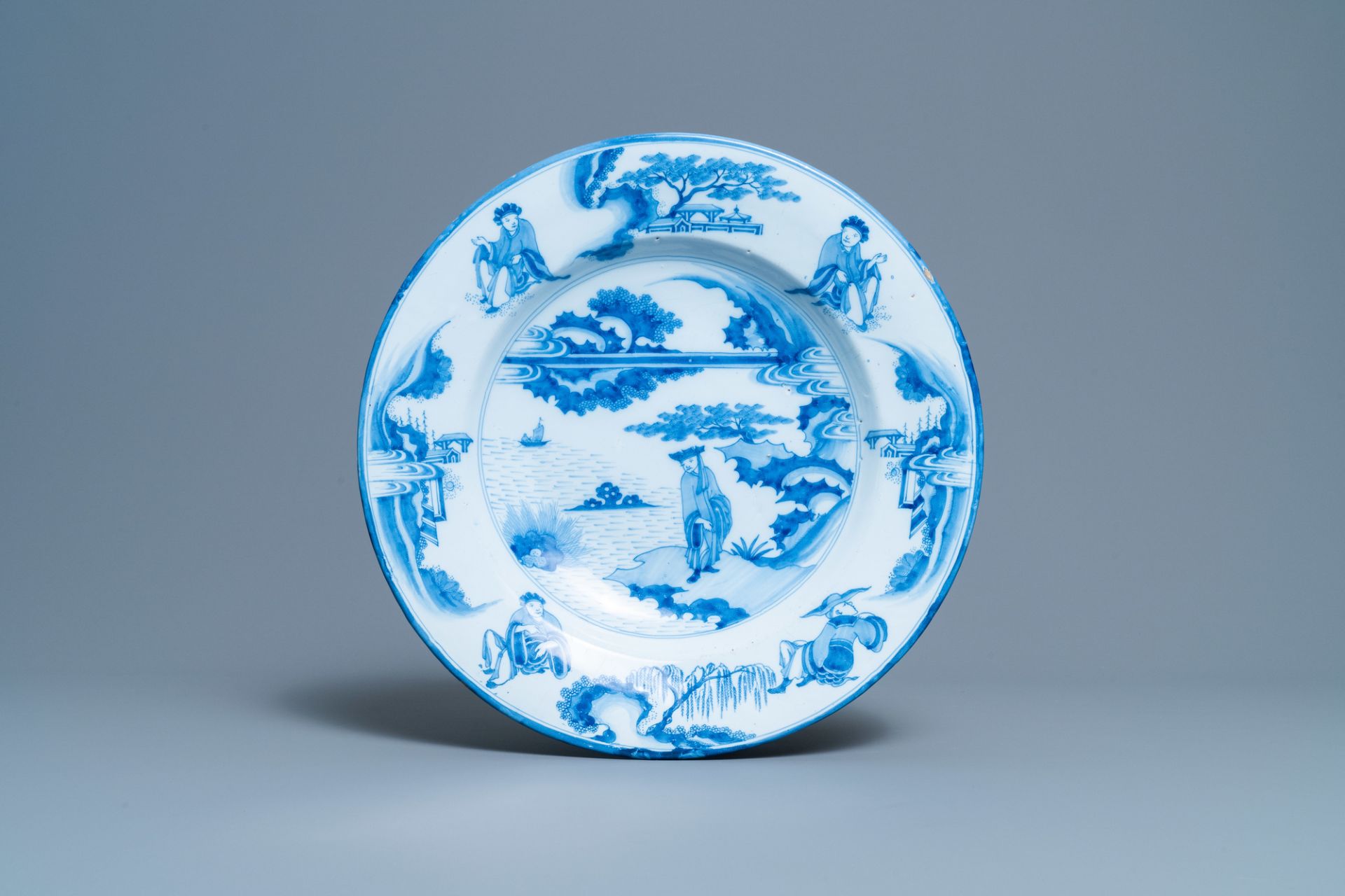 A Dutch Delft blue and white chinoiserie dish with figurative medallions on the back, late 17th C.