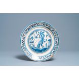 A blue, white and manganese Portuguese faience charger with a rabbit, 17th C.