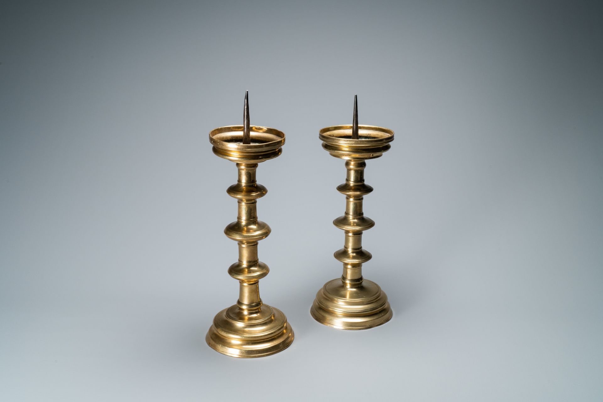 A composite pair of brass alloy candlesticks, Germany, 16th C.